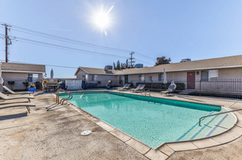 our apartments have a swimming pool with chairs and a roof