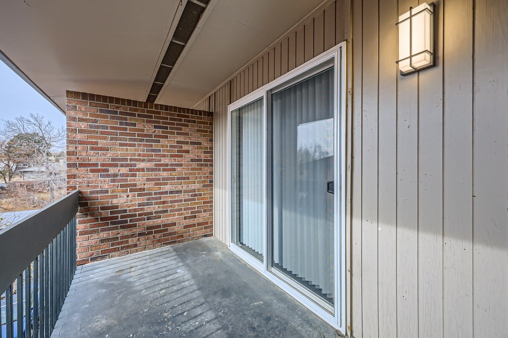 the front door of a condo with a brick wall
