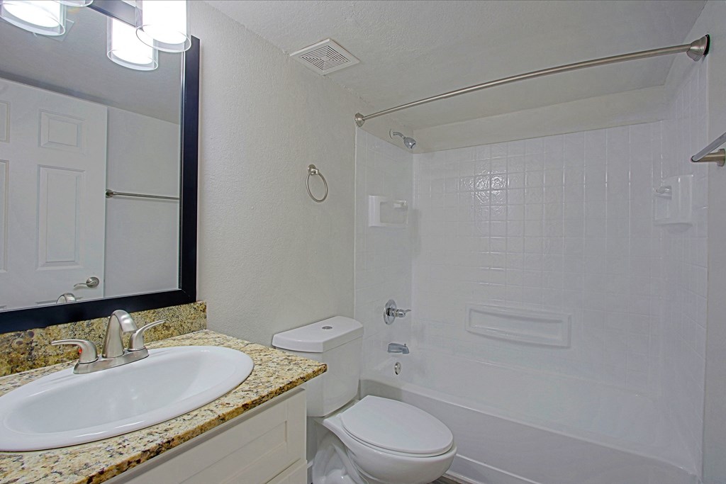 a bathroom with a sink toilet and a shower