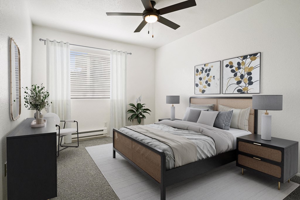 a bedroom with a bed and a ceiling fan