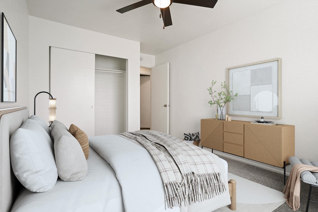 a bedroom with a large bed and a ceiling fan