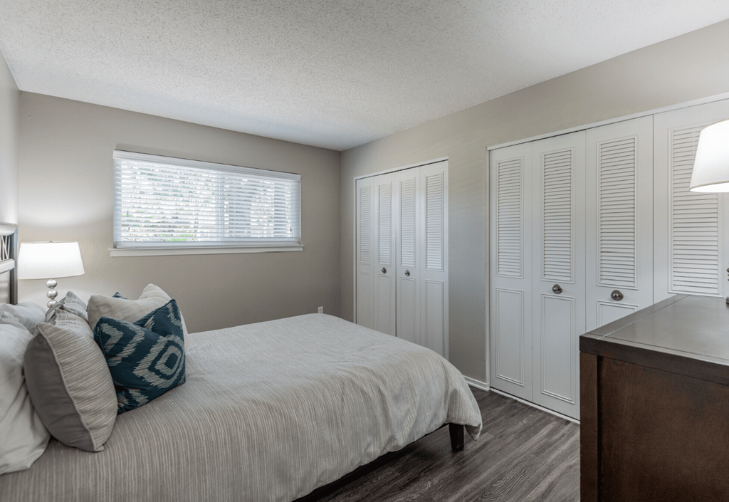 a bedroom with a large bed and white closets at Aspire Sacramento Apartments, Sacramento