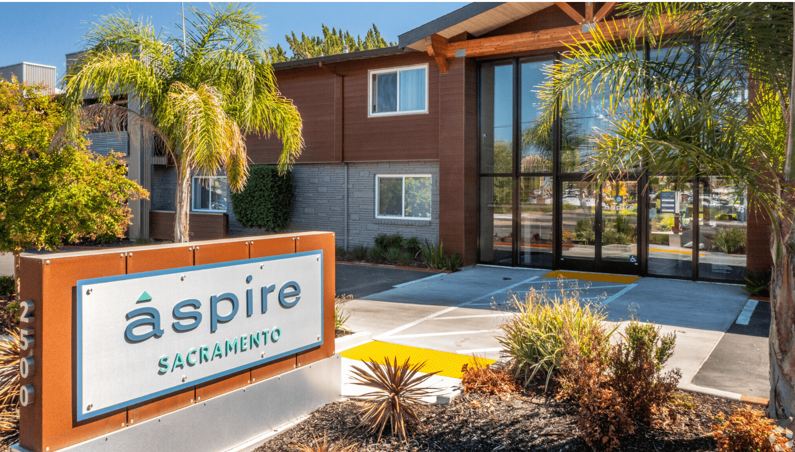 a picture of the aspire apartments sign in front of the building