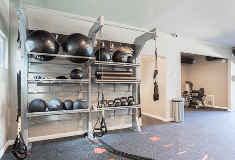 the weights room in the fitness center at the apartments