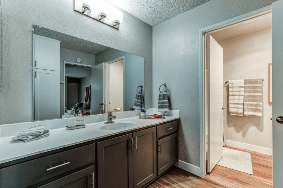 the master bathroom has a large mirror and a double sink at Aspire Upland Apartments, California, 91786