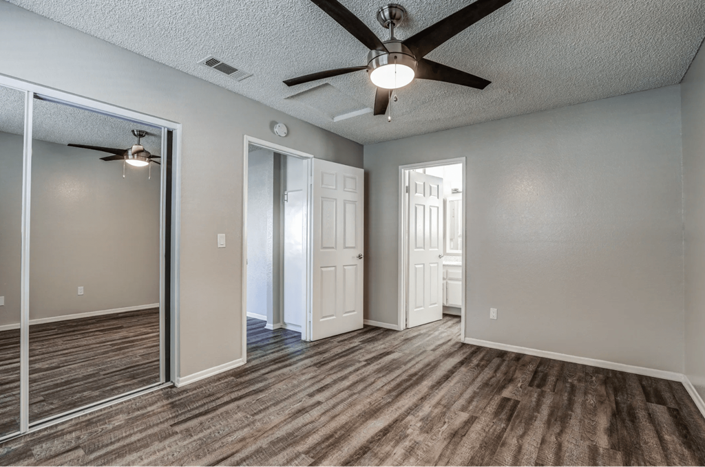 an empty living room with a ceiling fan at Aspire Seneca, Victorville, CA