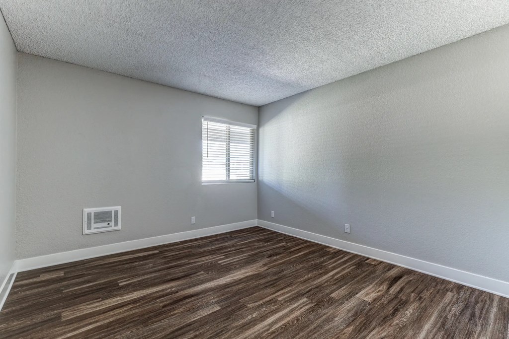 an empty living room with wood flooring and a window at Aspire Upland Apartments, Upland, 91786