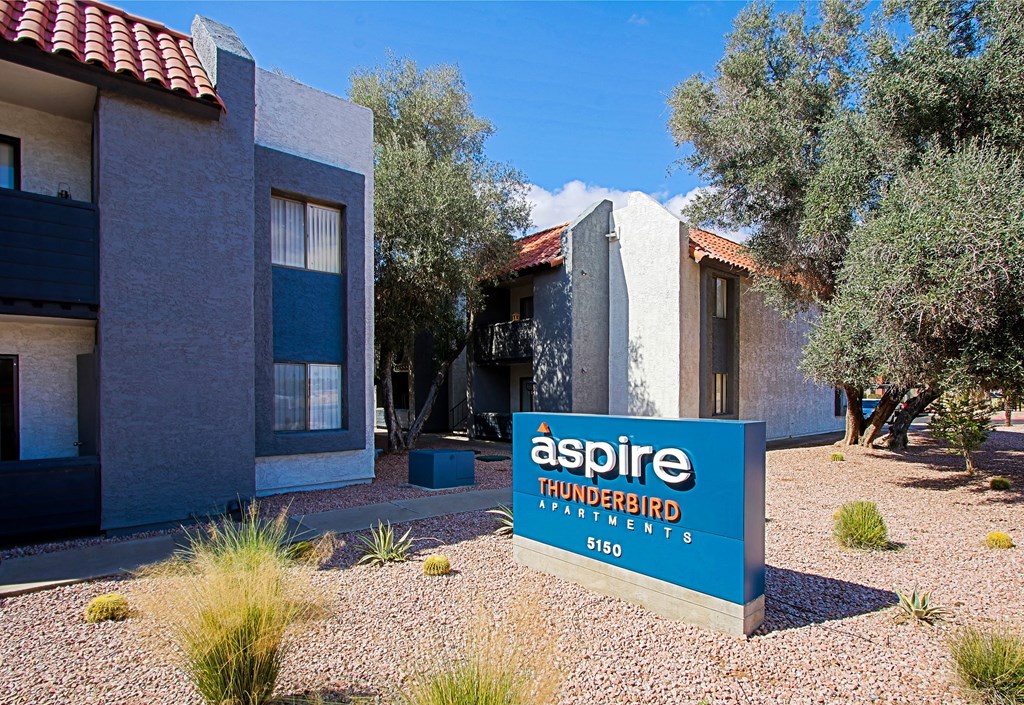 a building with a sign that reads aspire thunderbird apartments