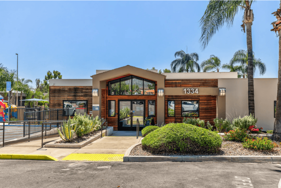 the front of a building with palm trees at Aspire Upland Apartments, Upland, CA, 91786