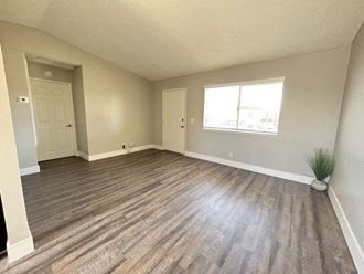 an empty living room with a large window  at Aspire Seneca, Victorville, CA