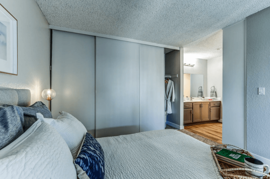 a bedroom with a large bed and a bathroom with a sink at Aspire Upland Apartments, Upland, 91786