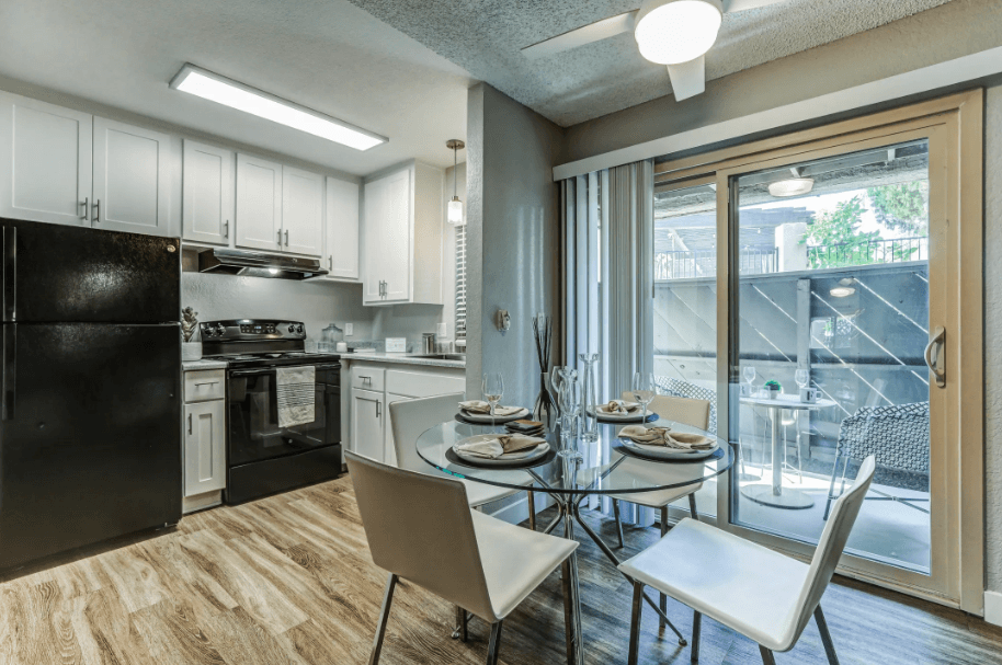 an open kitchen and dining room with a glass table and chairs at Aspire Upland Apartments, Upland, CA, 91786