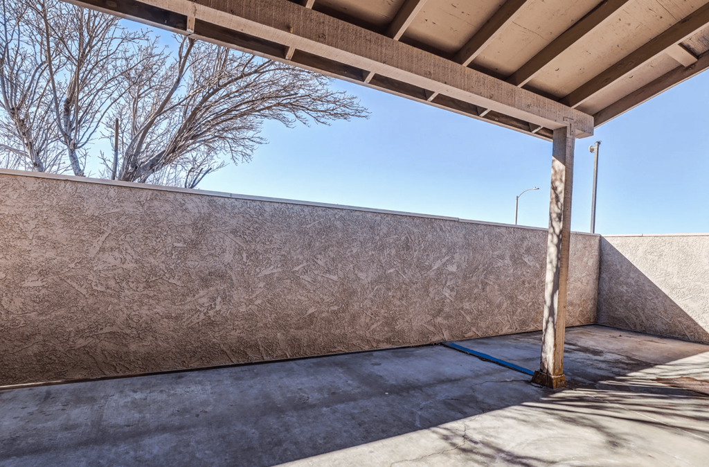 the patio of a building with a concrete wall and a wooden poleat Aspire Seneca at Aspire Seneca, Victorville, California