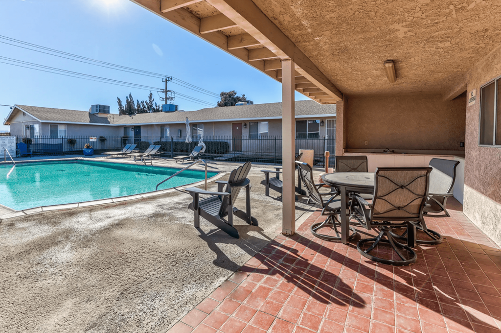 pool and a patio with chairs and tablesat Aspire Seneca, Victorville, 92392