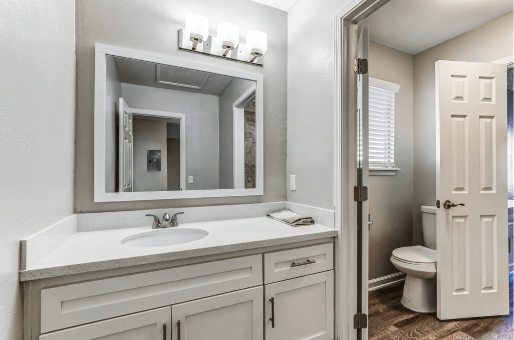 a bathroom with a sink and a mirror and a toiletat Aspire Seneca, Victorville