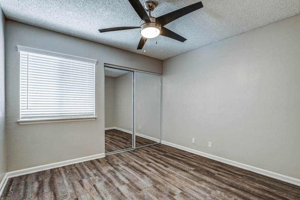 an empty room with a ceiling fan and a windowat Aspire Seneca, Victorville, 92392