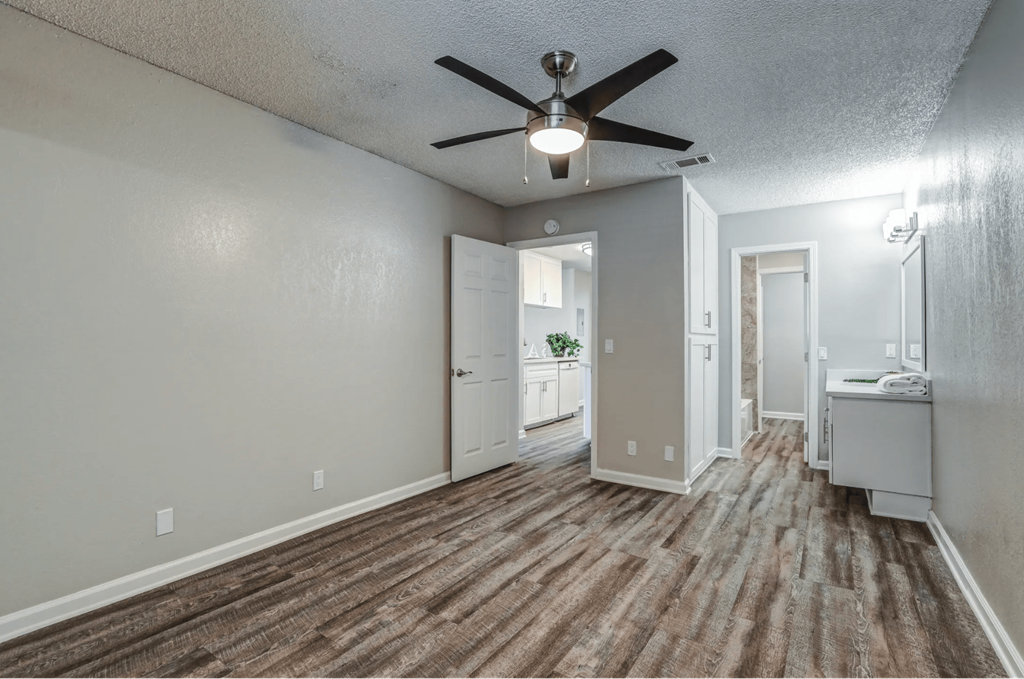 an empty living room with a ceiling fanat Aspire Seneca, Victorville, CA