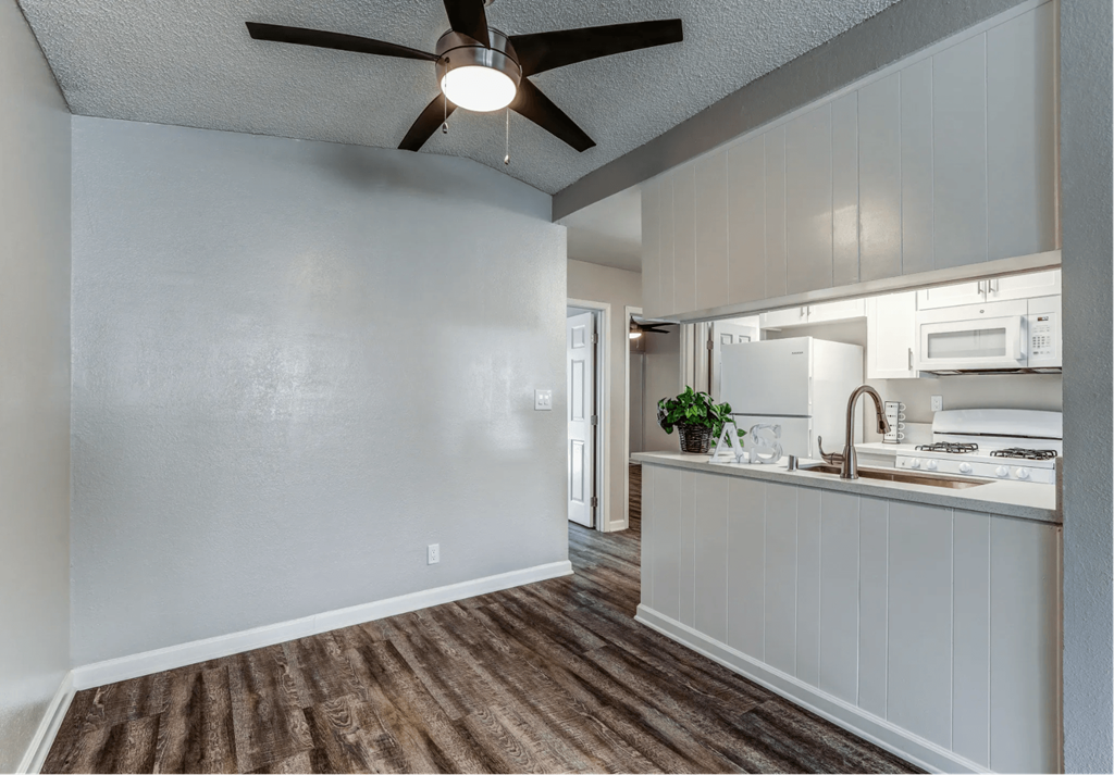 an open kitchen and living room with a ceiling fan at Aspire Seneca, Victorville, 92392