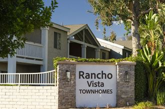 a building with a sign that reads rancho townhomes