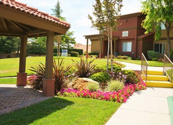 Arches at Regional Apartments in Antelope Valley CA - The Arches at Regional Center West - Kitchen with Black Appliances and Wood-Style Flooring - Photo Gallery 3