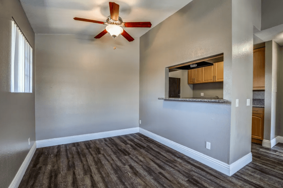 an empty living room with a ceiling fan at Vista Promenade Apartments, Temecula, California