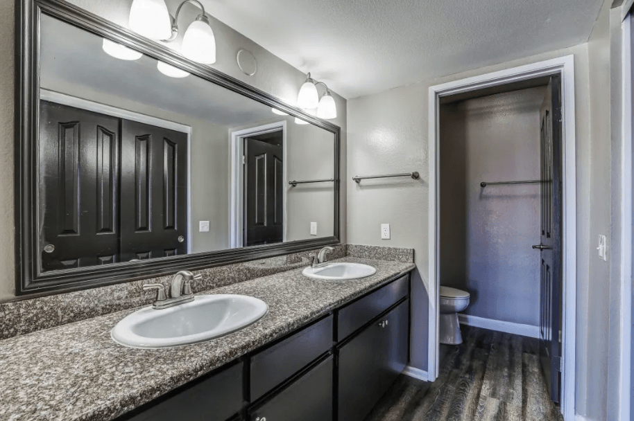 bathroom with granite countertops and side by side sink at Vista Promenade Apartments, Temecula