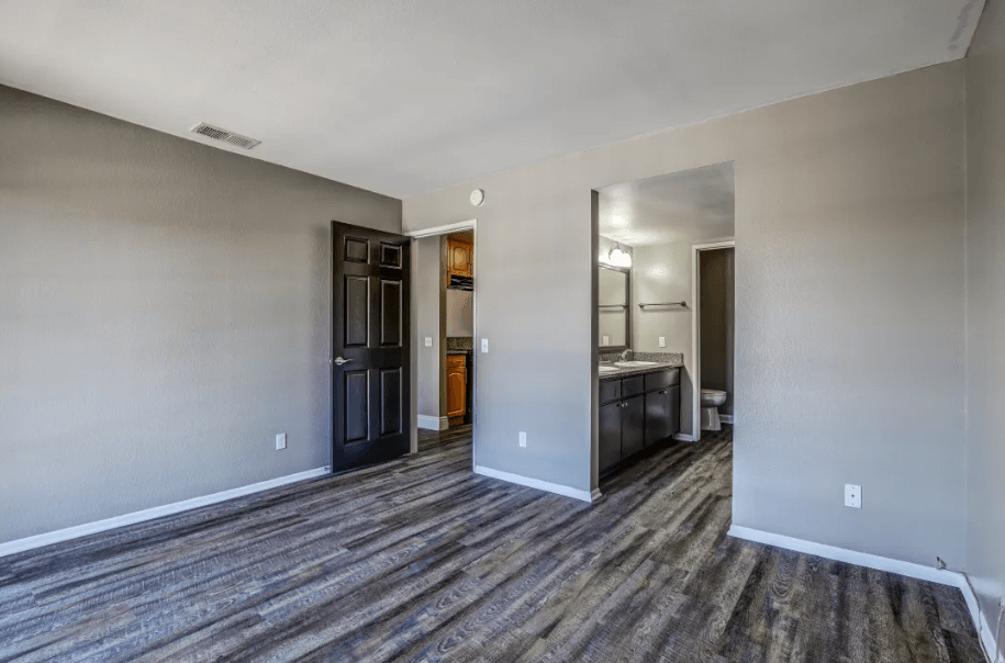 the living room and kitchen of a new home with wood flooring at Vista Promenade Apartments, California