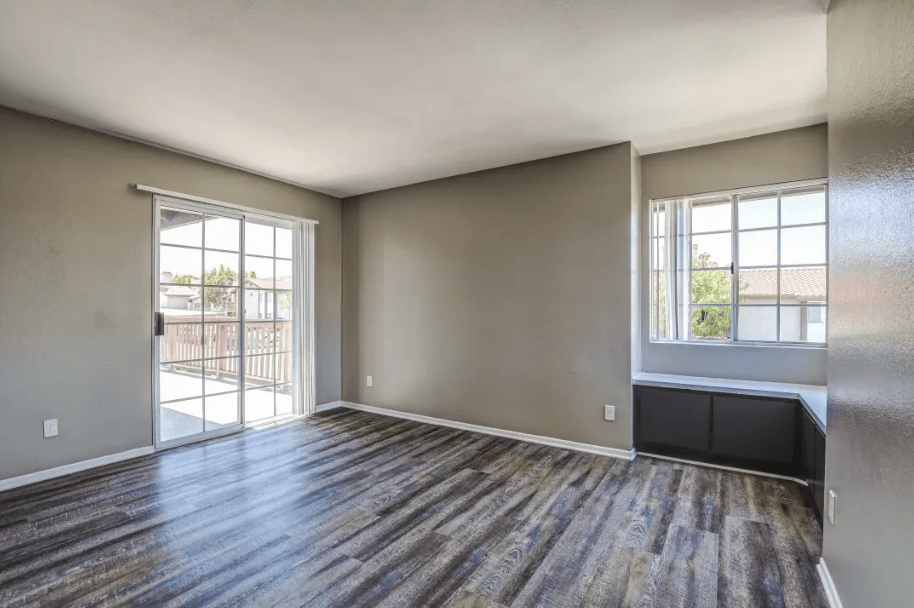 living room with wood flooring and a door to a balcony at Vista Promenade Apartments, Temecula, CA