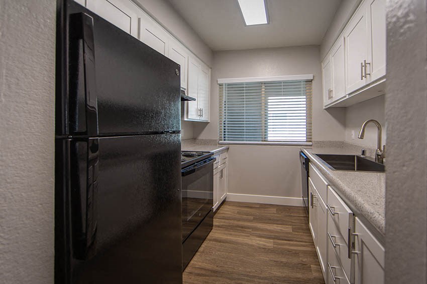 Unfurnished Living Room With Wood Flooring, Sliding Glass Door, and a Ceiling Fan at Aspire Upland Apartments, Upland, 91786