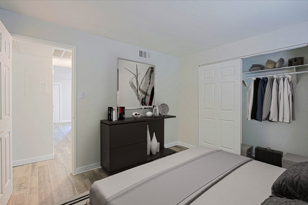 a bedroom with a bed and a dresser and a closet