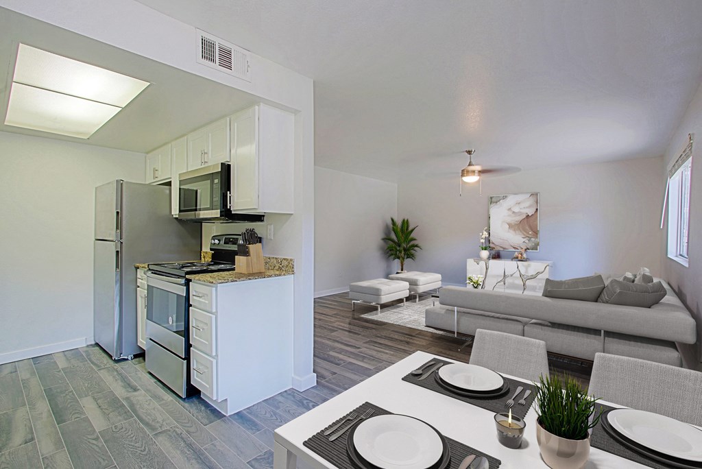 a living room with a kitchen and a dining table