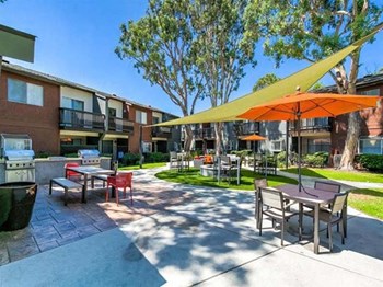 Apartments in Ontario CA - Expansive Courtyard at Encore Featuring Various Lounge Areas and Outdoor Amenities - Photo Gallery 6