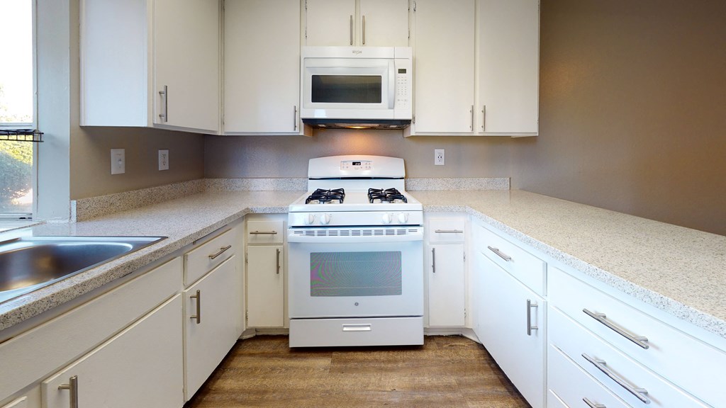 Apartments for Rent in Ontario CA  - Rancho Vista - Modern Kitchen With a Gas Stove, a Microwave, Sleek Counters, and Spacious Cabinets at Rancho Vista Townhomes, California, 91764