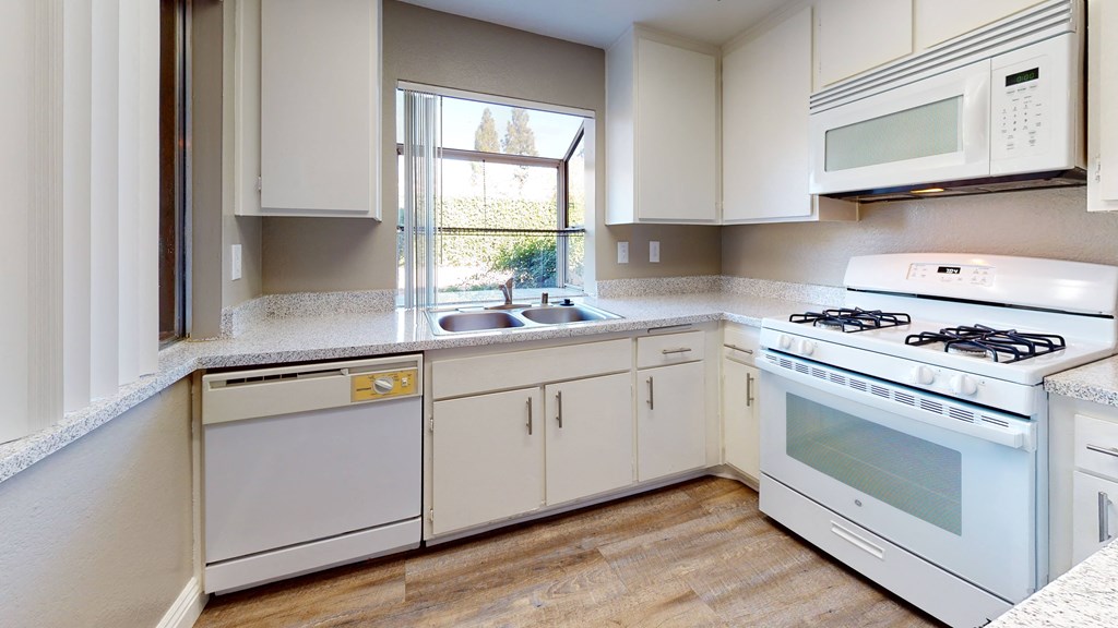 Apartments in Ontario for Rent - Rancho Vista - Modern Kitchen With a Dishwasher, a Microwave, a Gas Stove, and Abundant Cabinet Storage at Rancho Vista Townhomes, California