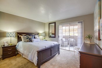Vista Promenade Apartments in Temecula - Bedroom with Stylish Decor, Wall to Wall Carpet, Beige Walls, and Access to Patio/Balcony - Photo Gallery 3
