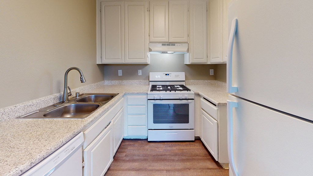  Kitchen with White Appliances, White Cabinetry, and Granite Countertops at Avante Apartments, Ontario, California