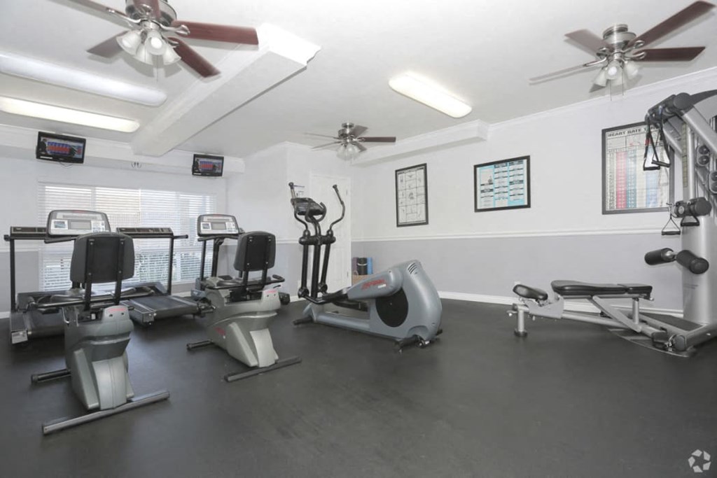 Fitness Center with Elliptical, Treadmills, Ceiling Fans, Large Window, and More at Tuscany Villas Apartments, West Covina, CA, 91791
