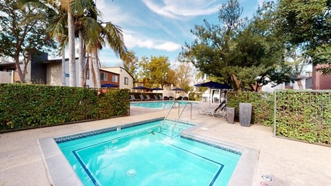 Ontario, CA, Apartments for Rent - Avante - Gated Hot Tub and Pool Area with Outdoor Greenery and Poolside Seating