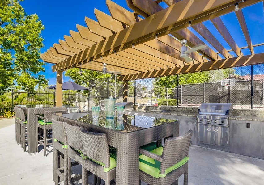 BBQ Area with Grills, Covered Patio, Modern Patio Furniture, and Ceiling Fan at Vista Promenade Apartments, Temecula
