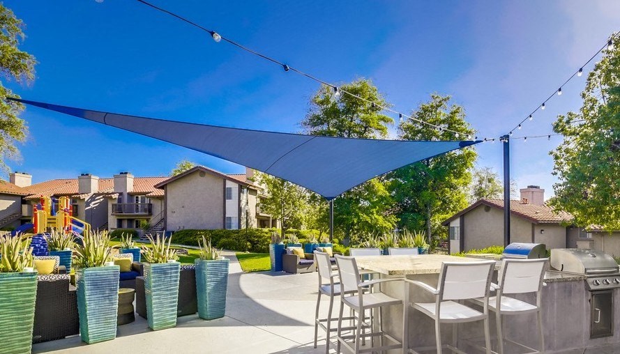 Exterior View of Vista Promenade Apartments Building Surrounded By Lush Landscaping with View of Outdoor Lounge at Vista Promenade Apartments, Temecula, CA