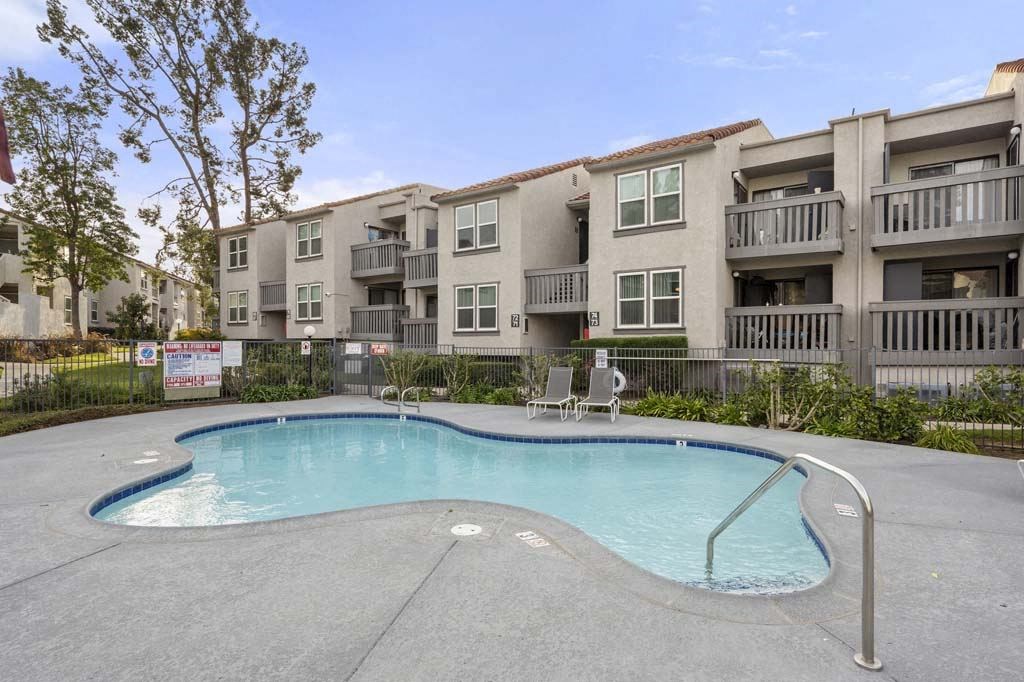 a swimming pool in front of an apartment building at Aspire Corona, Corona California