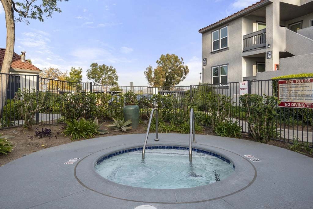 a hot tub with a fence in the background at Aspire Corona, Corona, 92882