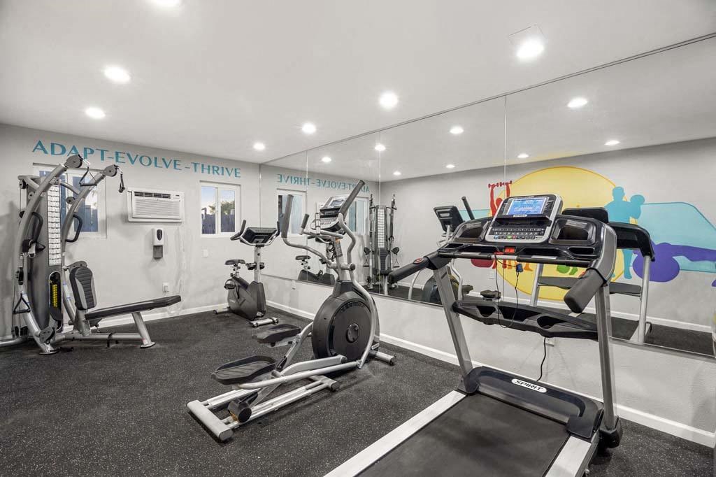 a gym with a treadmill and weights in it at Aspire Corona, Corona, CA 92882