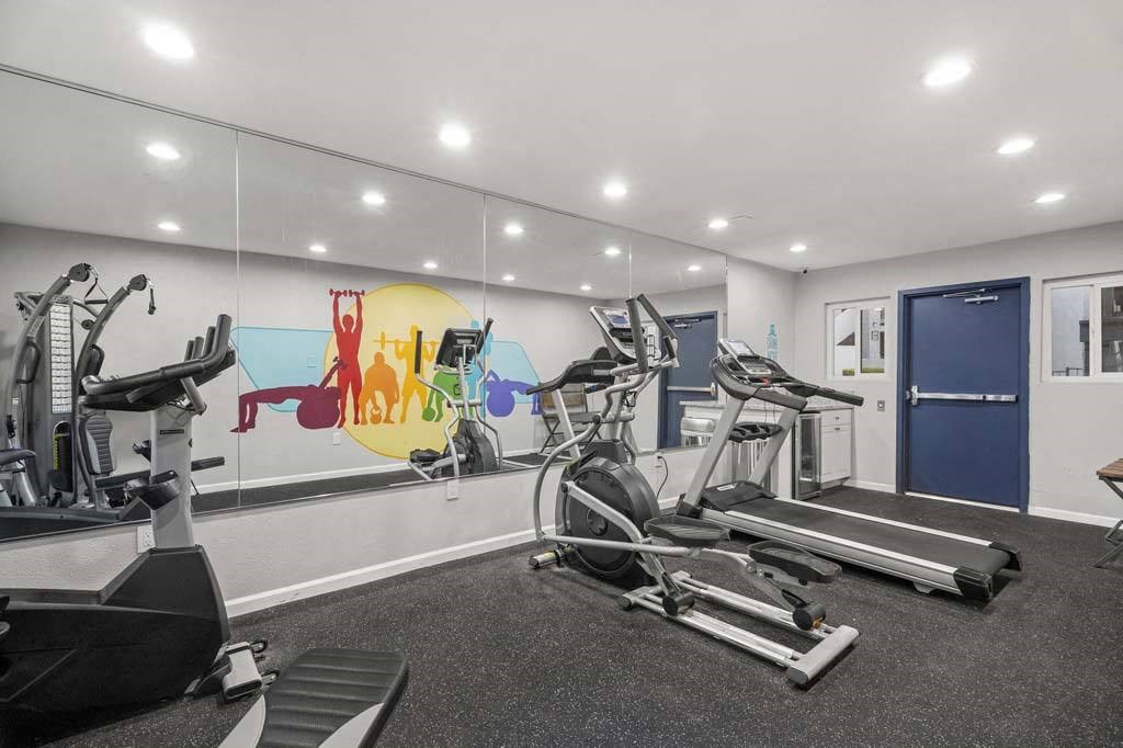 a gym with treadmills and other exercise equipment at Aspire Corona, California
