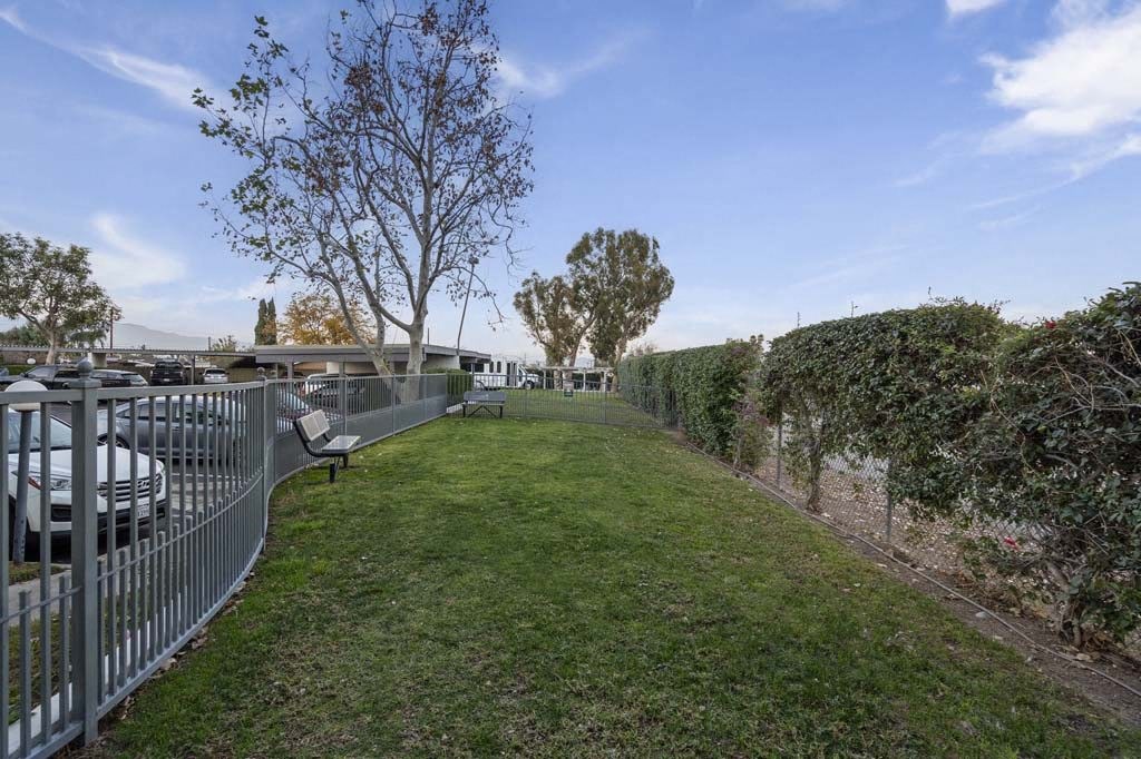 a grassy area with a fence on the side of it at Aspire Corona, California