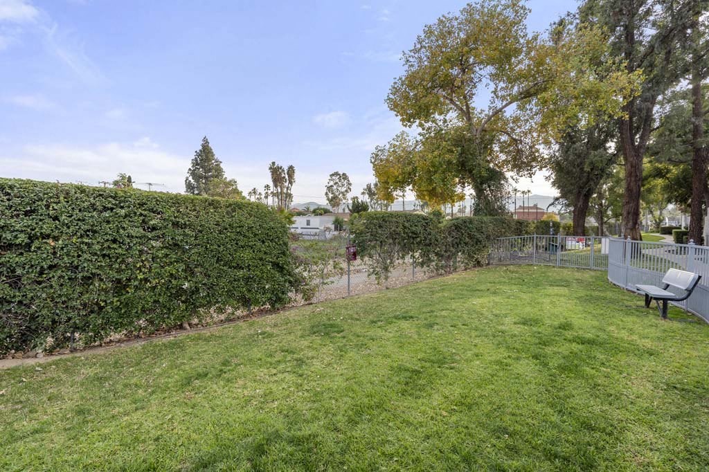 a large grassy area with a bench in the middle of it at Aspire Corona, Corona