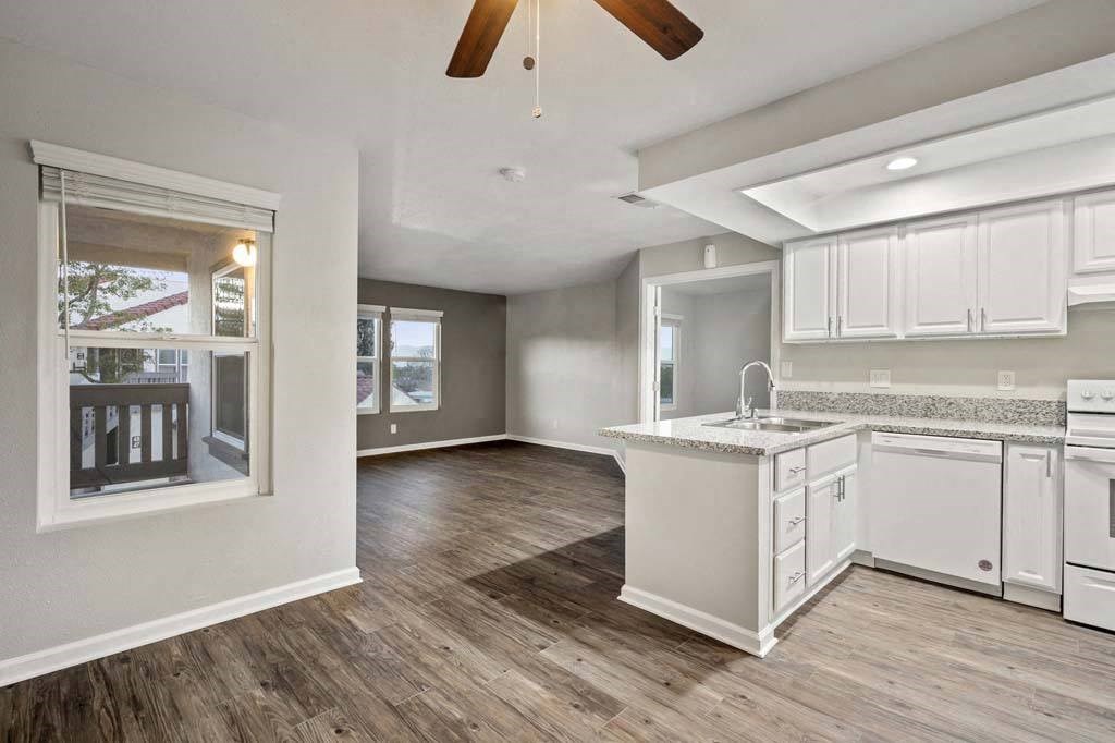 an empty kitchen and living room with a ceiling fan at Aspire Corona, Corona California
