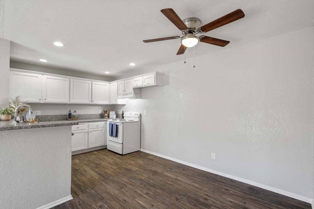 a kitchen and a living room with a ceiling fan at Aspire Rialto, Rialto
