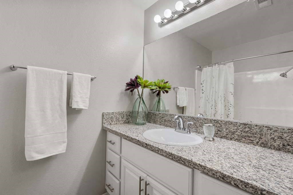 a bathroom with a sink and a mirror at Aspire Redlands, Redlands