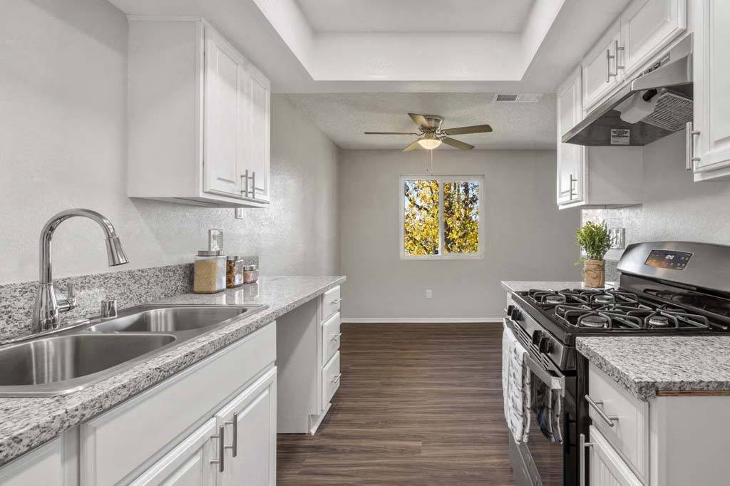 a kitchen with a stove top oven next to a sink at Aspire Redlands, Redlands California